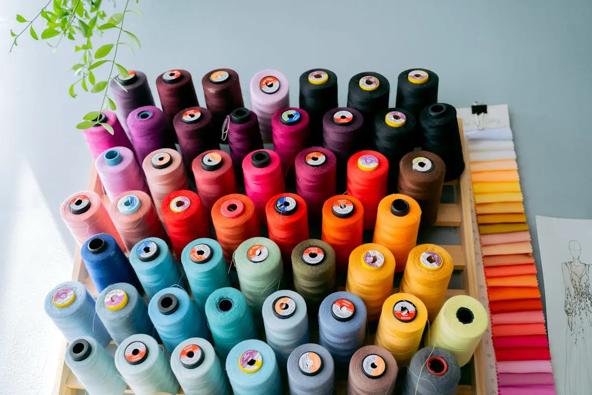 Expert Guide to the Best Janome Sewing Machine 1 Colorful sewing threads and fabric swatches in a creative studio workspace