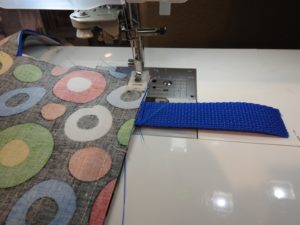 Photo of closing bottom seam opening where straps are terminated.