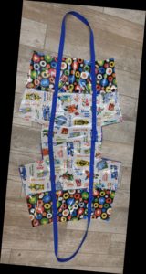 Photoof front and back of laminated cotton beach bag with straps