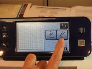 Put a Little Bling on Your Embroidery. The Brother Rhinestone Kit, Part 2. 46 Photo of ScanNCut screen with finger on Cut button