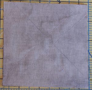 Photo of seam lines sewn for half-square triangles