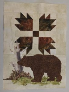 Photo of completed quilt block with half-square triangles