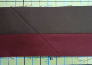 Make your Quilt Pop With Flange Binding 9 Photo of right side of red and brown flange binding showing seams that connect strips from end to end.