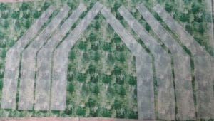 Little Miss Muffet is Making a Square Tuffet 7 Photo of interfacing for pattern pieces "2C" and "2CR" ironed on to the green fabric for the square tuffet