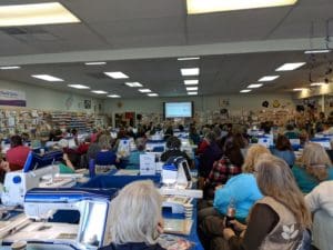 What's Happening: A Lot! February Happenings at RMSV 2 View from back of store of people and machines set up for Floriani Quilting event