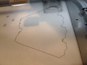 photo of placement stitch for free standing holiday wreath panel sewn out on Aqua Mesh