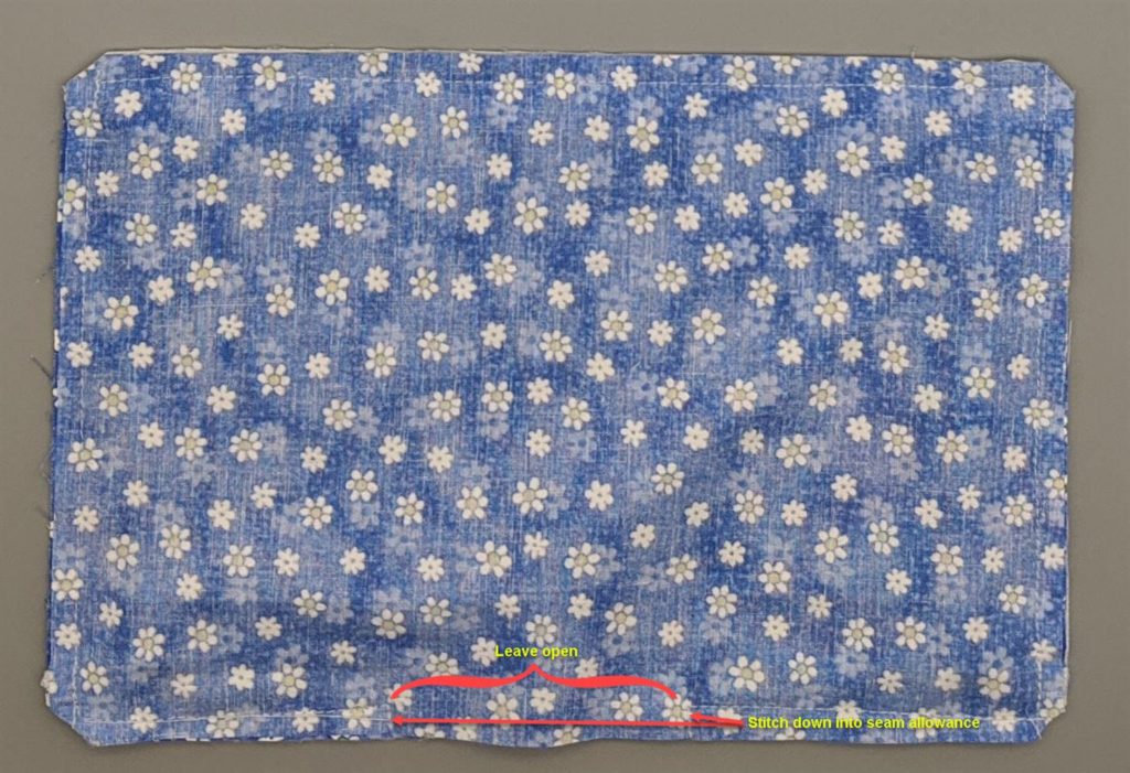 Annotated photo of wrong side of cotton face mask that has been stiched