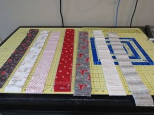 Ready, Set, Sew! A Jelly Roll Race at Rocky Mountain's Colorado Springs Store 1 Photograph of Jelly Roll Race quilt strips sorted by color