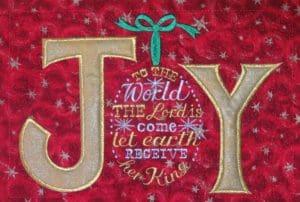 Don't Get Your Tinsel in a Tangle: Embroidering With Metallic Thread 2 The word Joy and some of the song "Joy to the World" sewn out with metallic thread