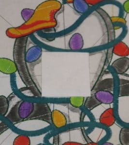 Don't Get Your Tinsel in a Tangle: Embroidering With Metallic Thread 11 Photo of cut out center square the size of the Brother snowman
