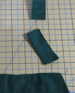 Don't Get Your Tinsel in a Tangle: Embroidering With Metallic Thread 20 Photo of neck strap with three inch piece cut from end of neck strap