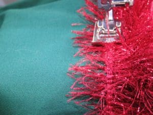 Don't Get Your Tinsel in a Tangle: Embroidering With Metallic Thread 23 Photo of machine foot while sewing along cord in fringe
