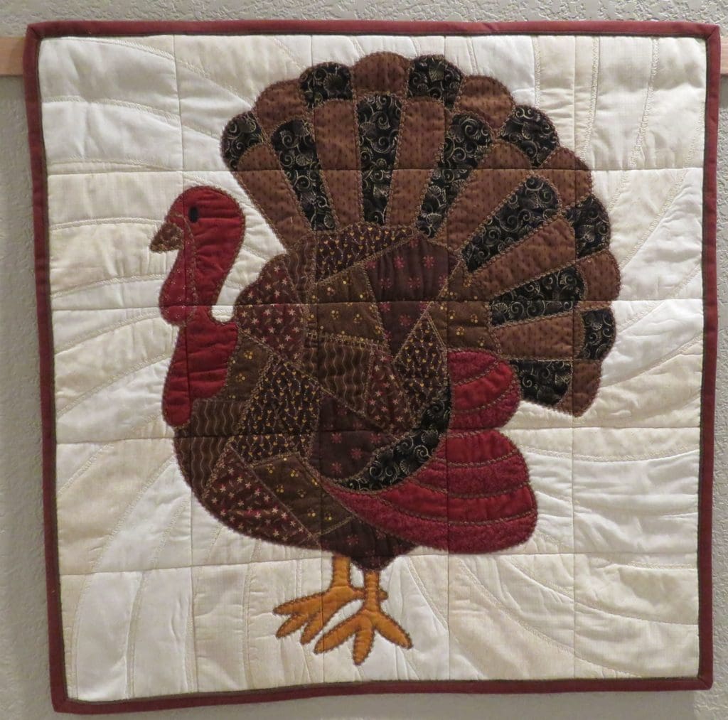 Make your Quilt Pop With Flange Binding 13 Photo of finished turkey quilt wall hanging with red and brown flange binding