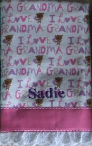 Photo of embroidered flannel burp cloth with ribbon and lace on bottom