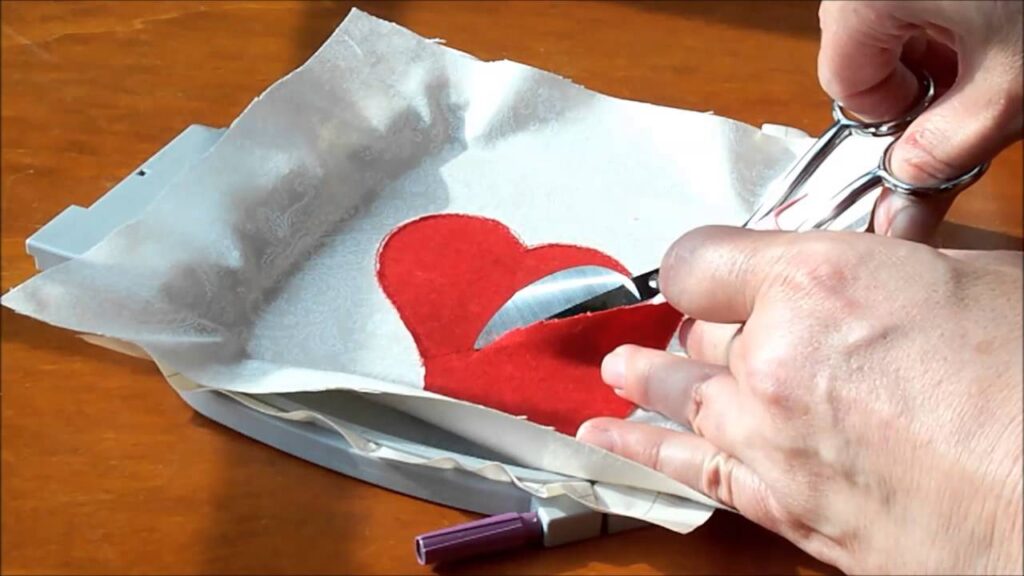 Cutting around the tackdown stitch of an applique