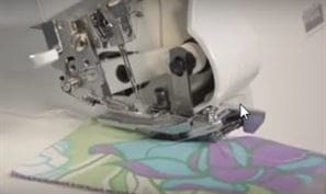Don't Get Ruffled, Get Ruffling: Gather Fabric Using a Serger 7 Photo showing when you gather fabric using a serger the ruffle fabric goes face up under the gathering foot.