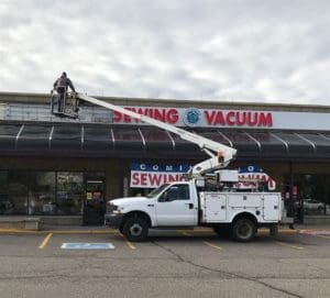 What's Happening: A Lot! February Happenings at RMSV 6 Photo of crane installing signage at Aurora store