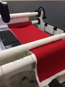 Handi Quilter Event: The Basics, Tips and Tricks I Learned 3 Photo of small quilt sandwich set up on long arm to test tension